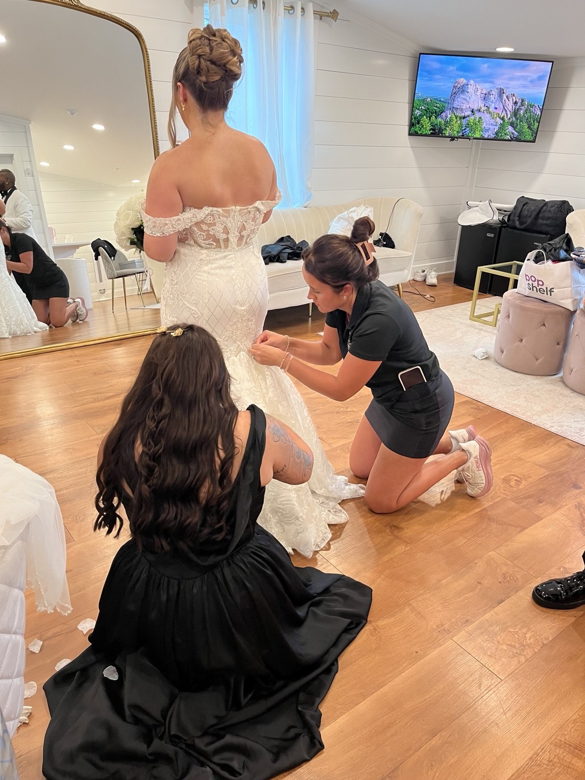 Wedding coordinator helping a bride with her dress